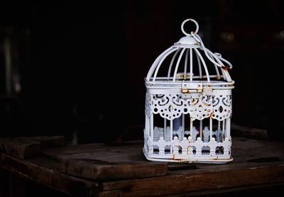 Close-up of small birdcage on table