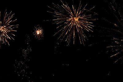 Low angle view of firework display at night