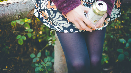 Low section of woman standing on grass