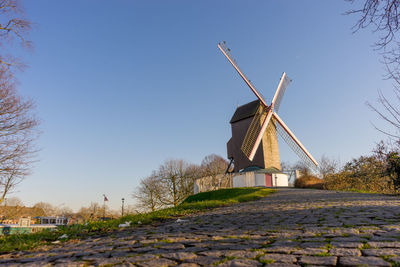 Traditional windmill against clear blue sky