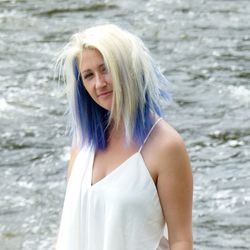 Portrait of beautiful young woman standing in water