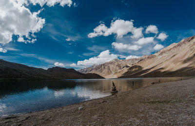 Scenic view of lake and mountains against sky