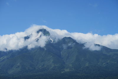 Low angle view of mountains against blue sky