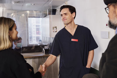 Patients and doctor at reception desk