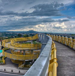High angle view of yellow bridge over sea against sky