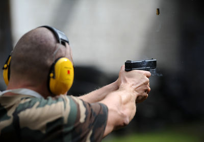 Army man shooting gun outdoors