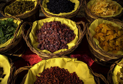 High angle view of dried fruits in wicker baskets at market