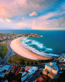 High angle view of sea and cityscape against sky