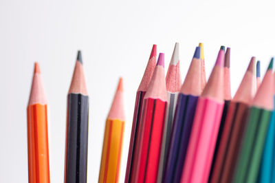 Close-up of colored pencils against white background