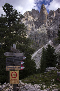 Information sign on rock against sky