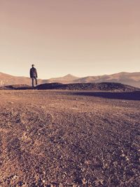 Rear view of man in the desert against sky