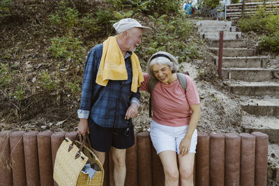 Cheerful senior couple hiking together in forest