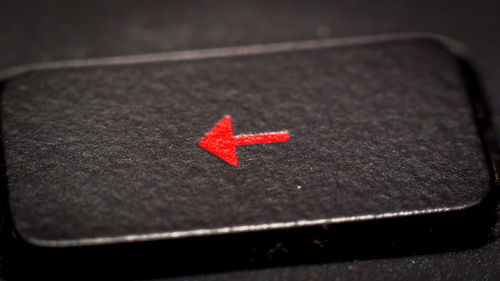 High angle view of red arrow symbol on table
