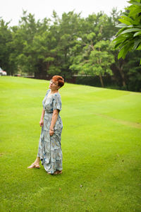Full length of woman standing on field