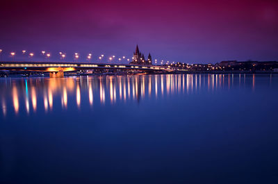 Reflection of illuminated bridge in water