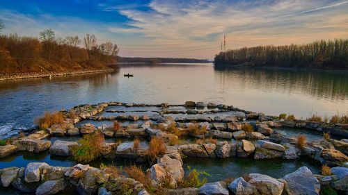 Scenic view of lake against sky at sunset