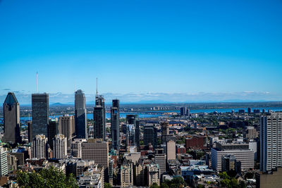 High angle view of cityscape against blue sky