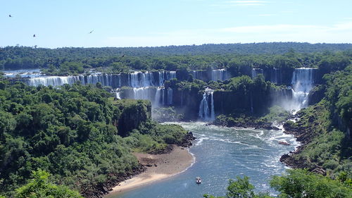 Scenic view of waterfall against sky