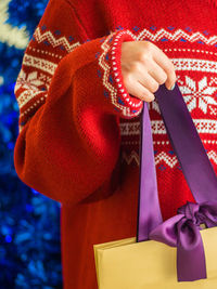 Midsection of woman holding bag during christmas