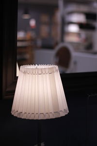 Close-up of electric lamp on table at home