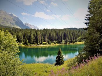 Scenic view of lake and mountains against sky