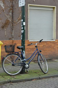 Bicycle against building in city