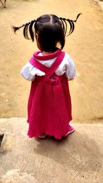 Rear view of girl standing outdoors