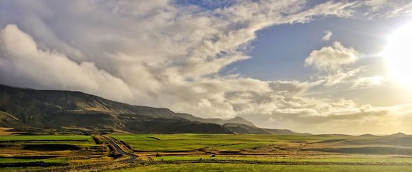 Scenic view of agricultural field against sky