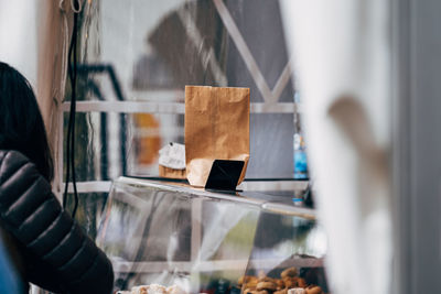 Empty paper bag standing on tray on market