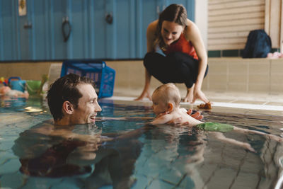 Father with baby in swimming-pool