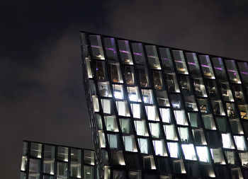 Low angle view of illuminated building against sky at night