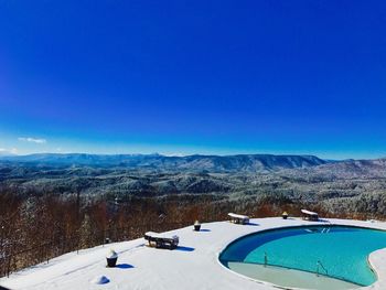 Aerial view of mountain range against blue sky