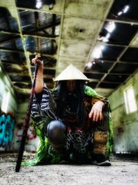 Full length of man sitting in traditional clothing