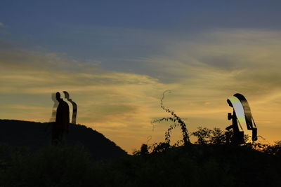 Silhouette man standing against sky during sunset