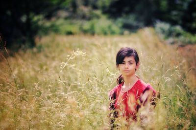 Portrait of woman standing on field