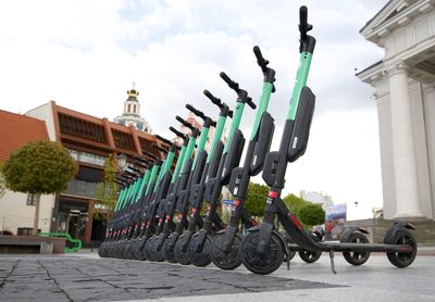 Bicycles parked in row against buildings in city