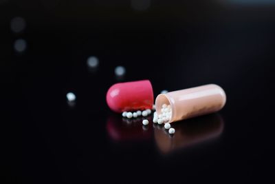 Close-up of pink object on table against black background