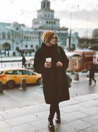 Full length of woman standing on street