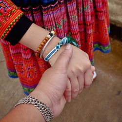 Cropped image of couple holding hands