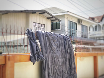 Close-up of clothes hanging on railing against building