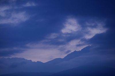 Low angle view of mountains against blue sky