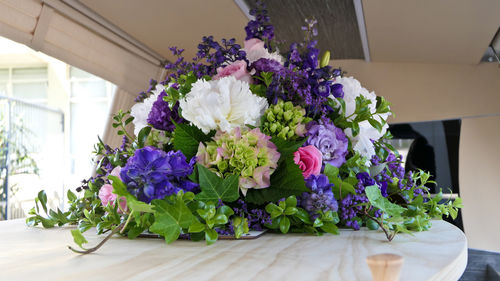 Closeup shot of a funeral casket or coffin in a hearse or chapel or burial at cemetery
