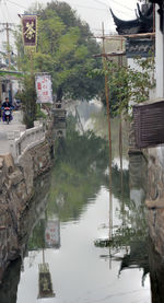 Boats in canal along buildings