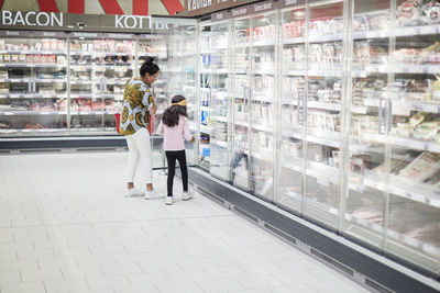 Mother with daughter in supermarket