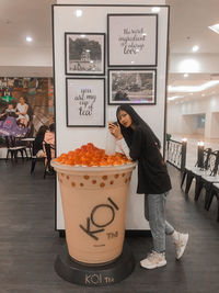 Woman standing by food in store