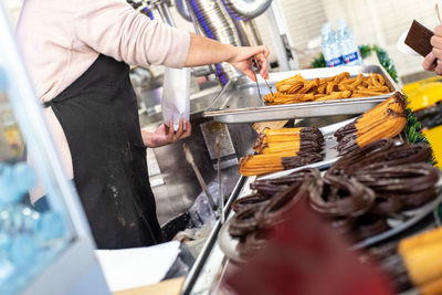 Midsection of man having food at market