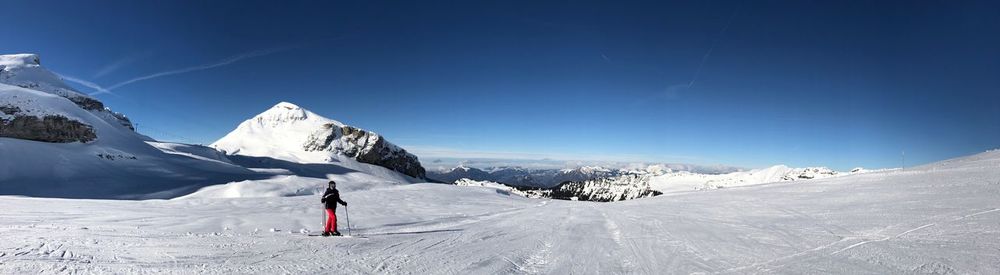 Man on snowcapped mountain against sky