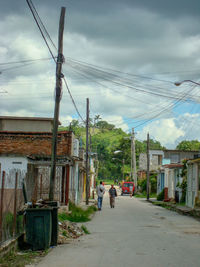 Street amidst buildings in city against sky