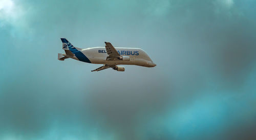 Low angle view of airplane flying against sky