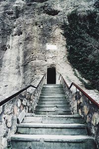 Low angle view of staircase in old tunnel